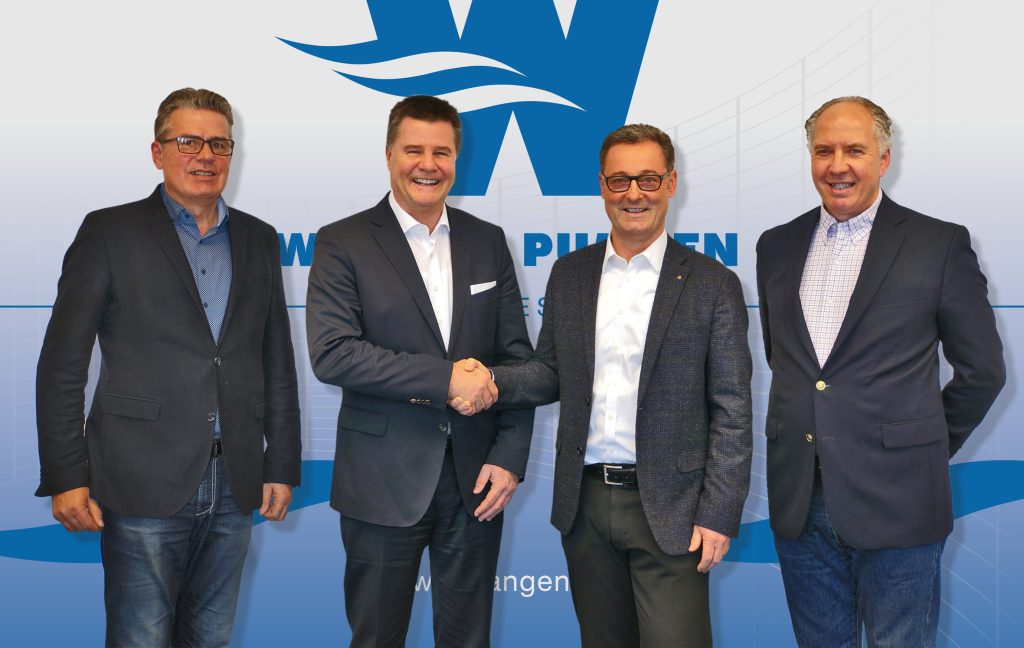 Four men stand next to each other
